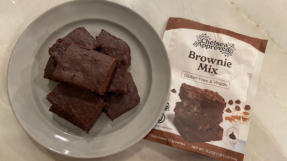 On the left is a gray plate with a pile of gluten free oil freebrownies on it and on the right is a bag of Chelsea Approved Brownie Mix